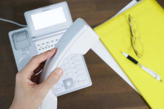 ご相談の電話を受ける前の受話器とデスク周り